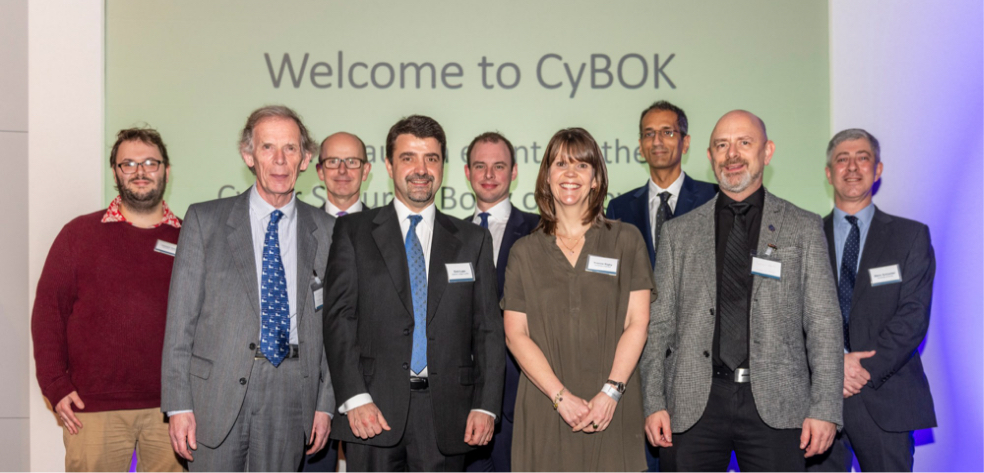 An image of 9 people standing together at CyBOK.