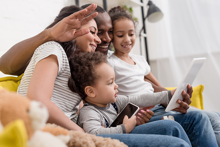 Image of family using devices