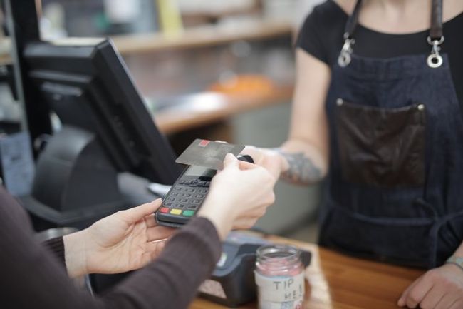 Customer paying for goods in a shop with a card.