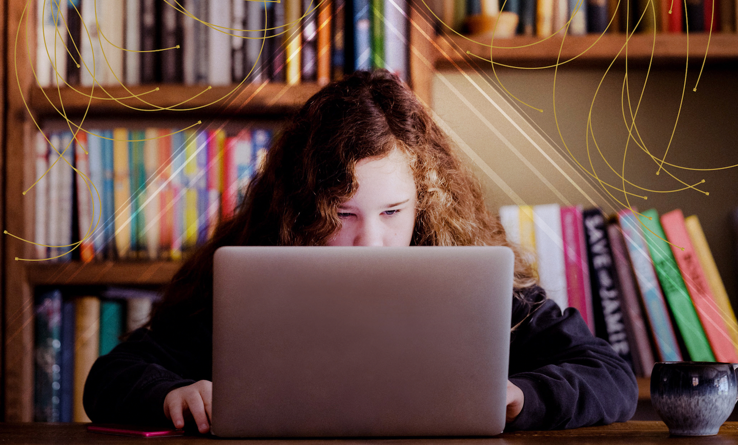 A young person looking at a laptop