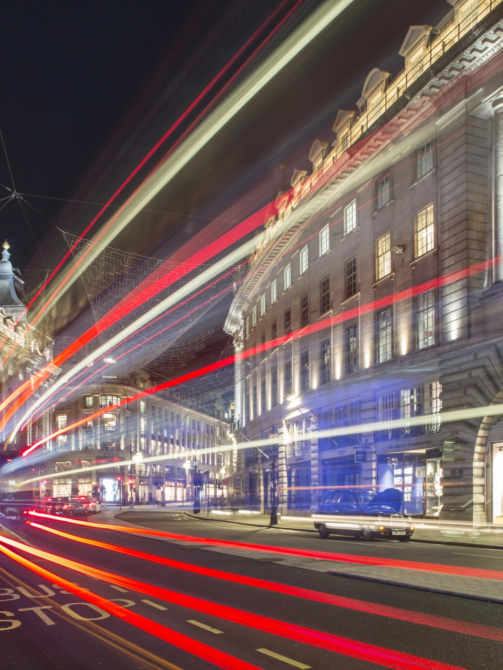 Image showing blur of bus light through the street
