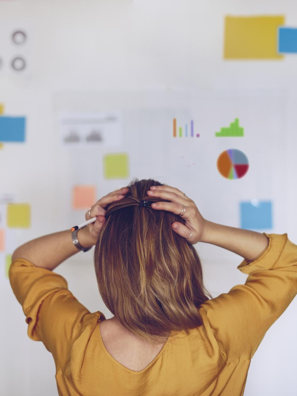 Woman standing in front of chart full of notes