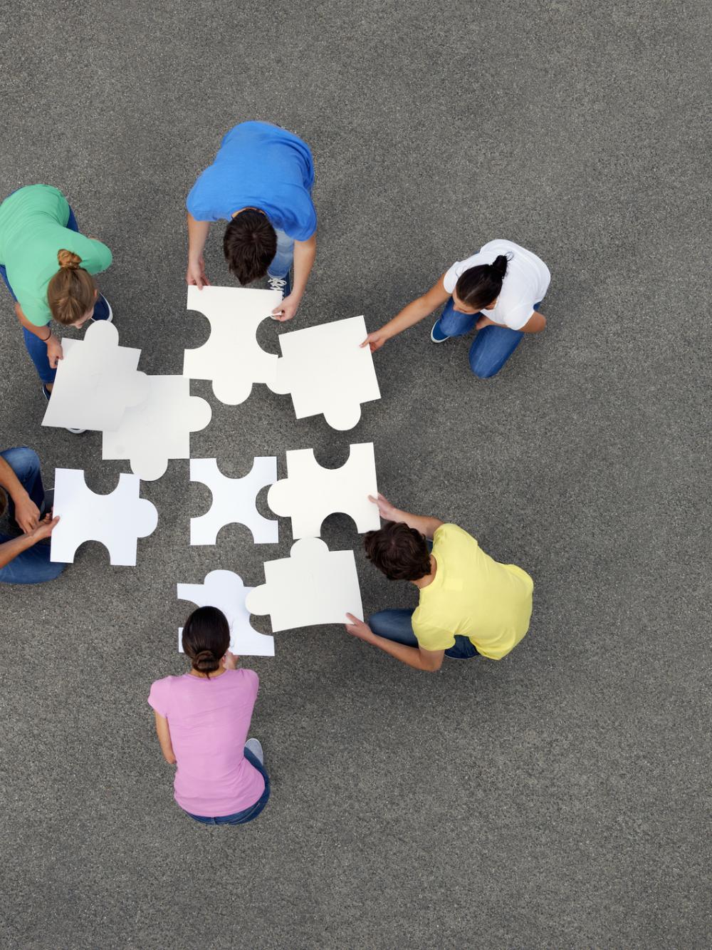 People putting together jigsaw puzzle