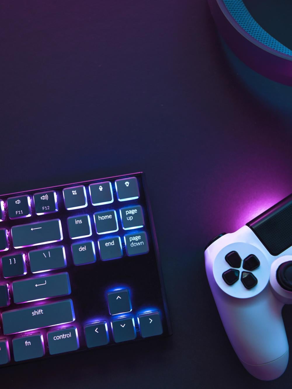 Two people holding gaming controllers in front of TV while gaming online