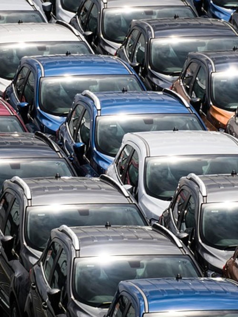 Image of the roofs of lots of new cars in a car park