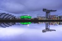 Glasgow skyline at night with reflection in Clyde river