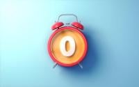 red alarm clock with white number zero in the middle