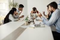 Meeting, with Chair holding head in hands during animated discussion