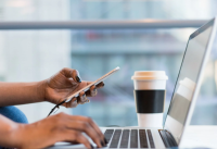 Decorative image of someone using laptop and 2FA