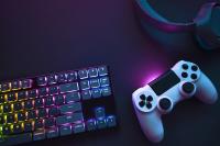 Two people holding gaming controllers in front of TV while gaming online