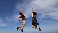 Man and woman jumping in the air